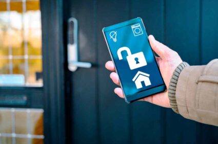A woman hand with handphone ans smart home lock